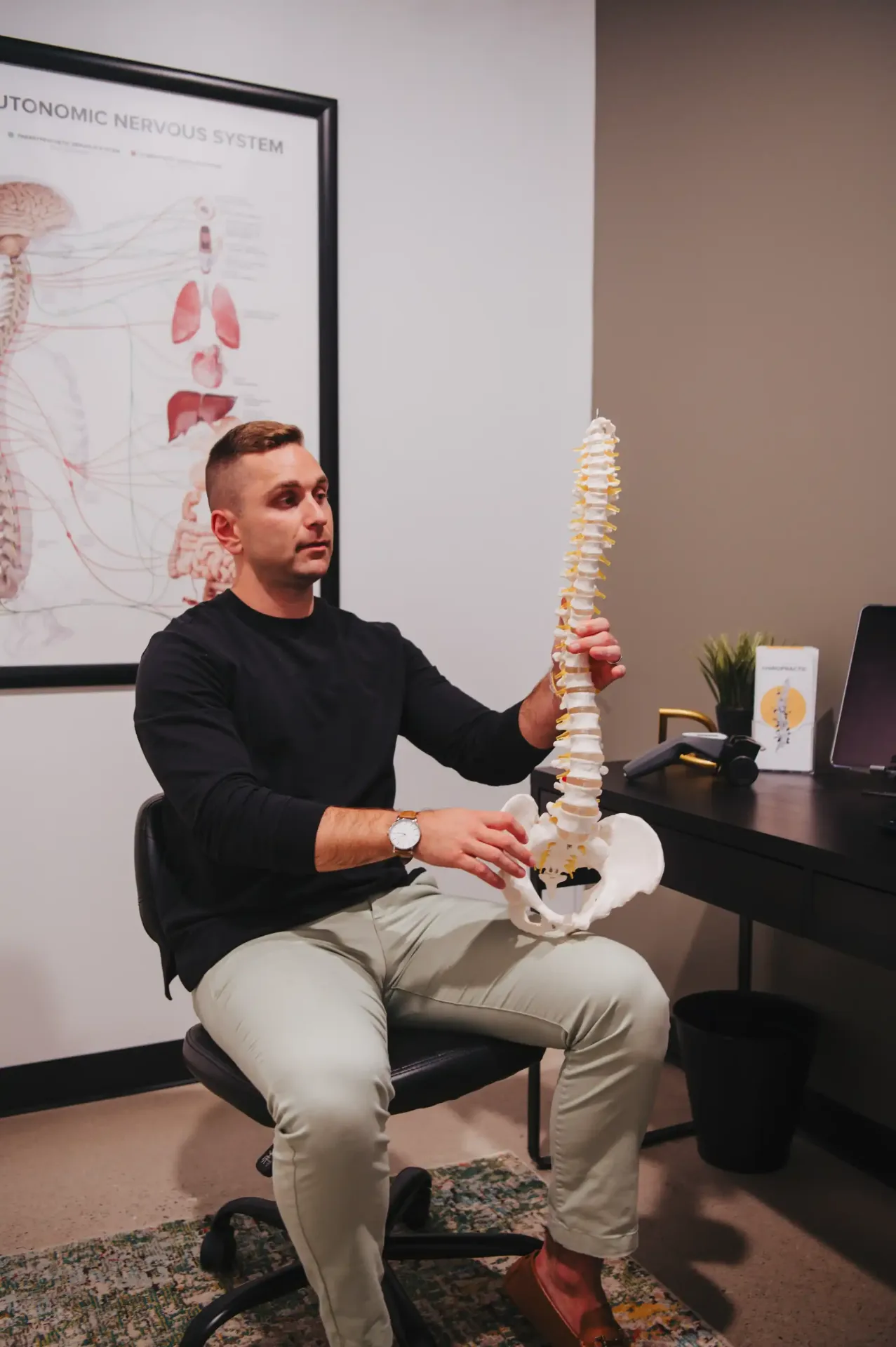 Dr. Sam explaining the spine and nervous system with an anatomical model