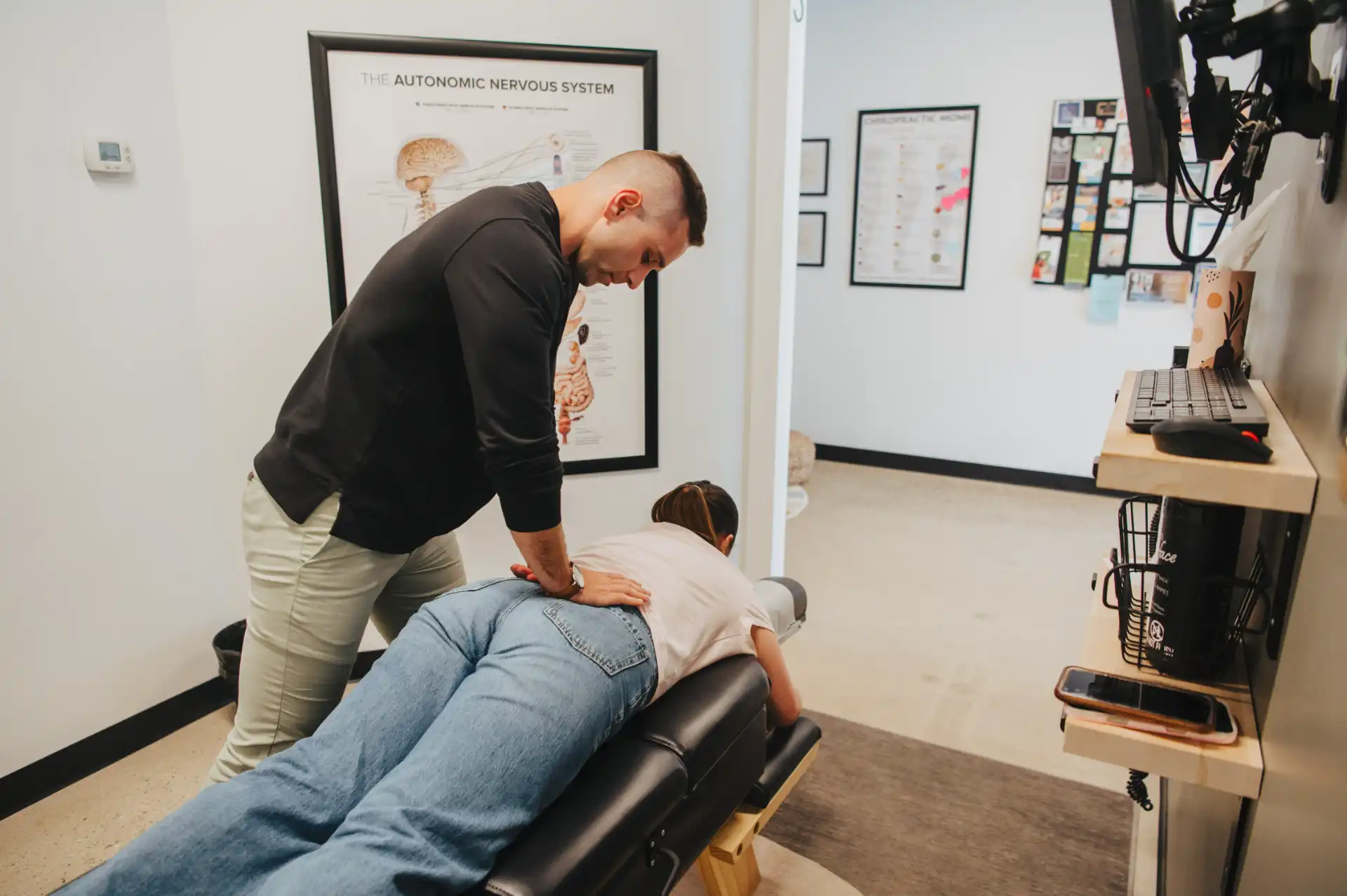 Dr. Sam adjusting a practice member in the Fishers chiropractic office