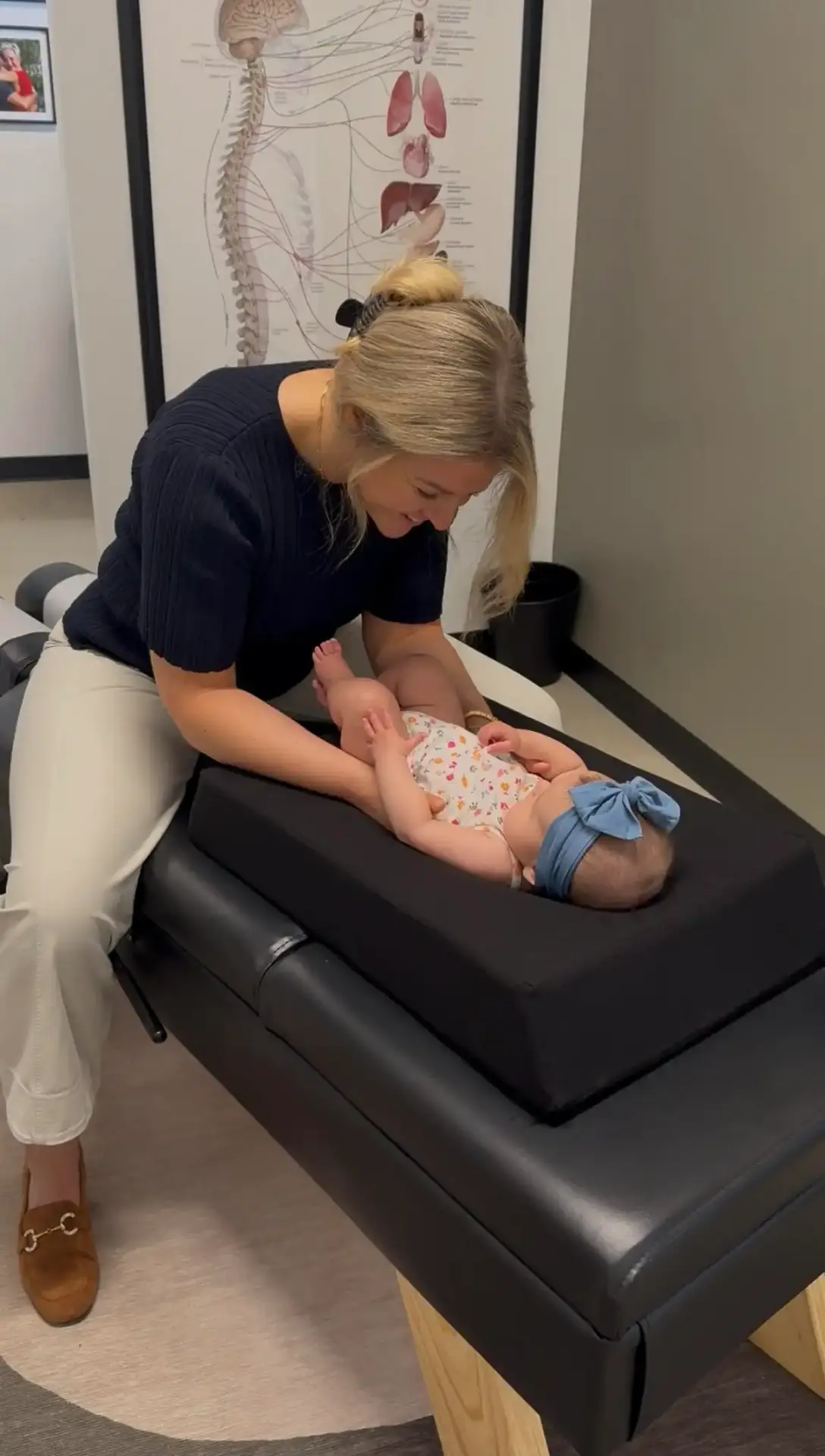 Dr. Sam providing gentle pediatric chiropractic care to a baby